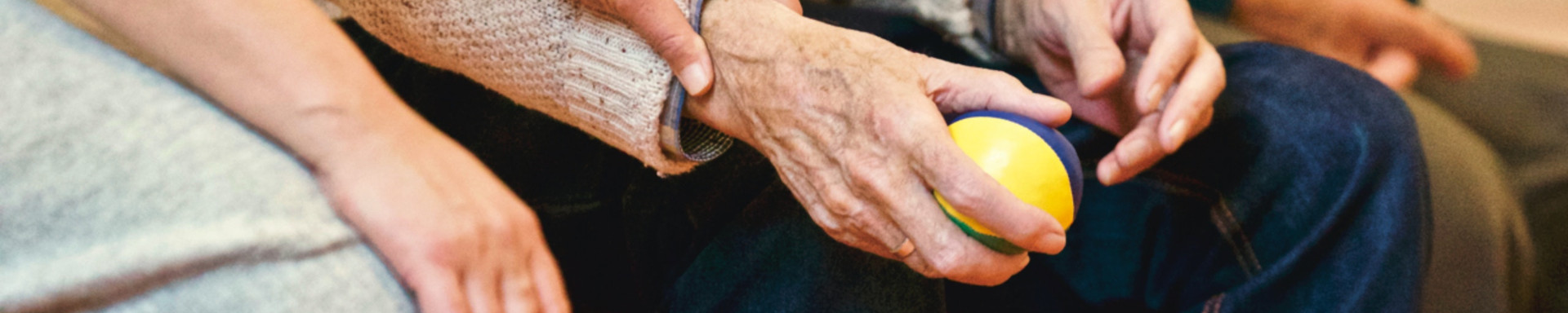 picture of daughter grasping right hand of elderly father